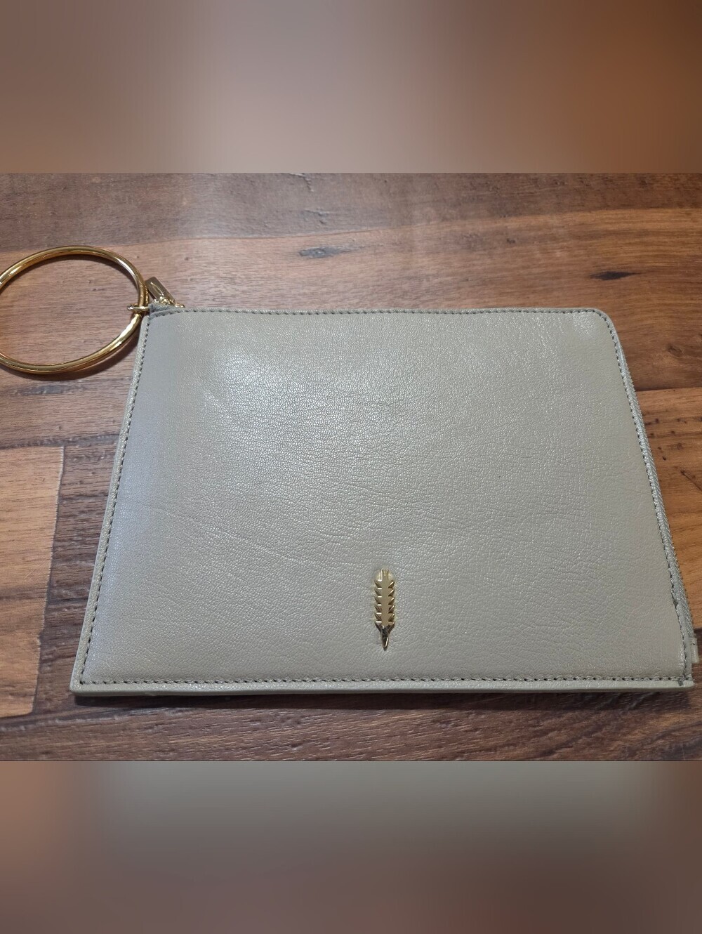 Thacker Beige Pebble Leather Wristlet Clutch with Gold Ring.